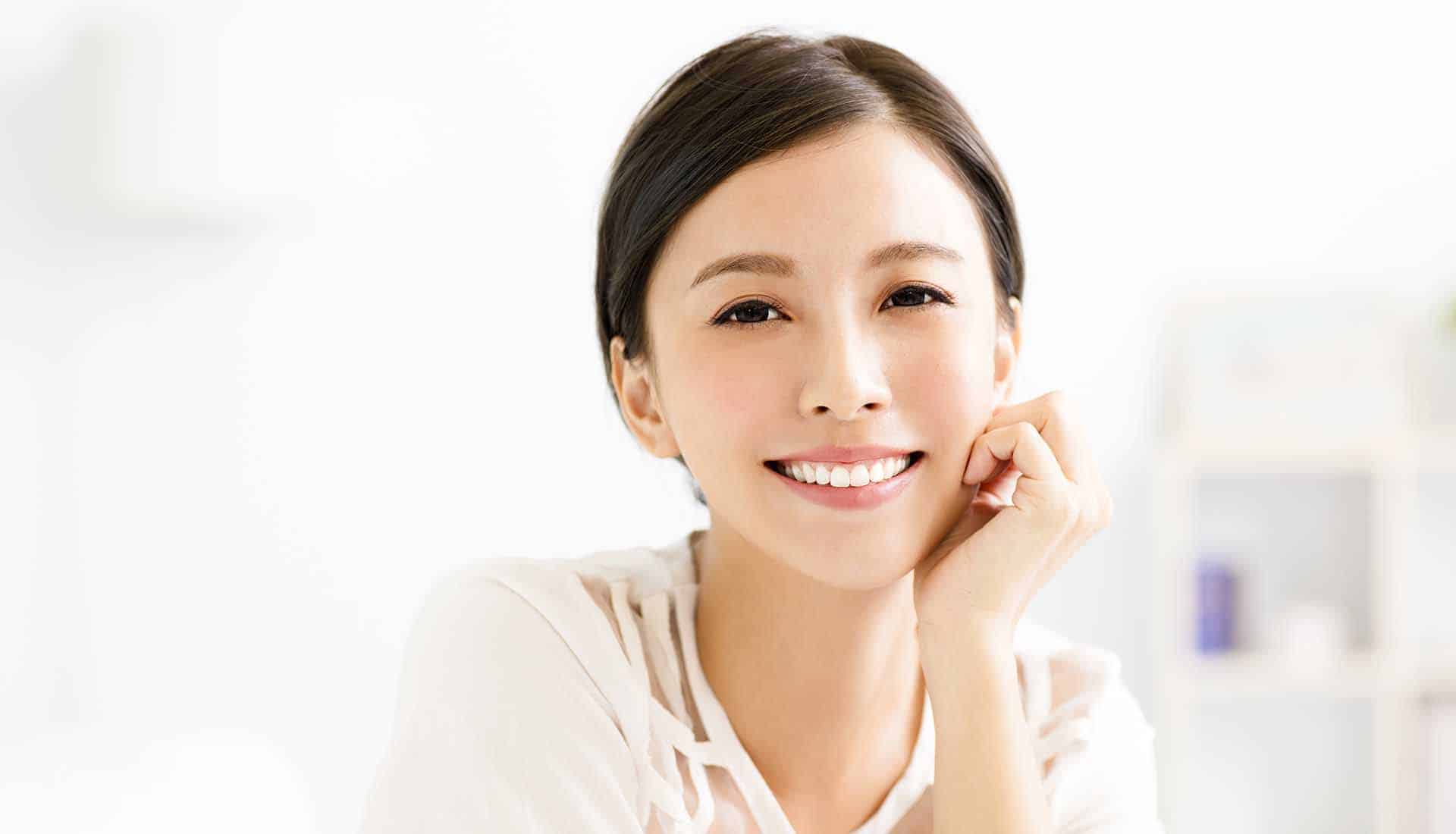 closeup smiling young asian woman face in living room