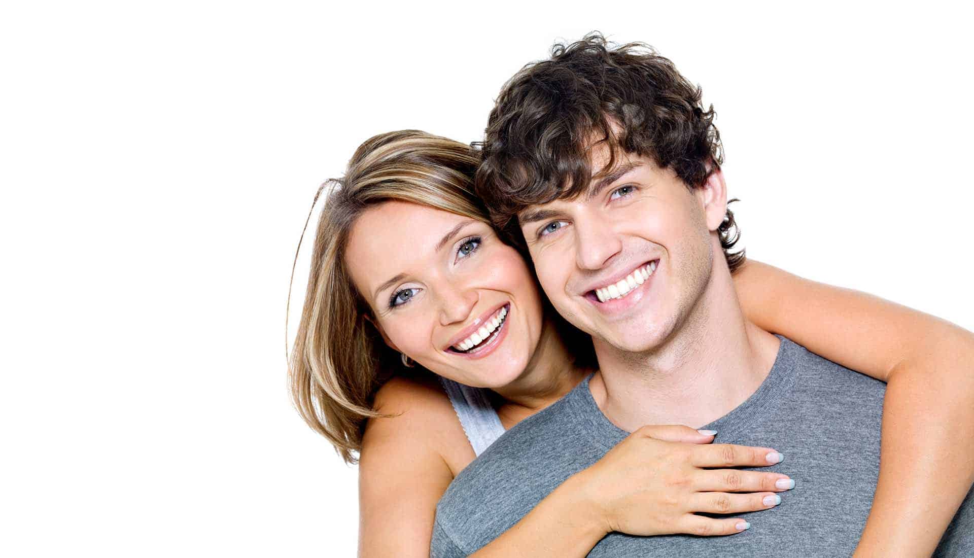 Portrait of a beautiful young happy smiling couple on a white background.